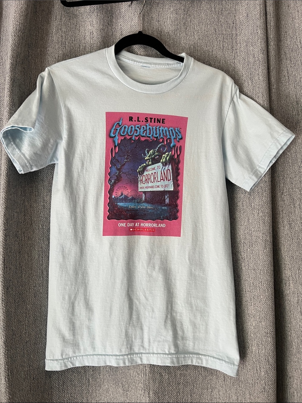 R.L. Stine Goodebumps Light Blue Tee with Pink Goosebumps Graphic